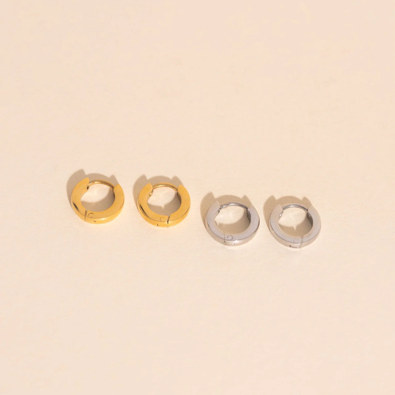 Smooth Tiny Huggie Hoop Earrings - Image 11